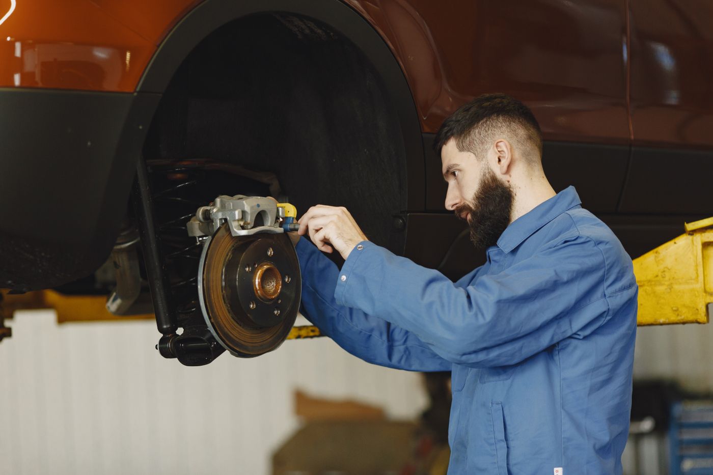 Brake pad replacement, wheel off, rotor visible.